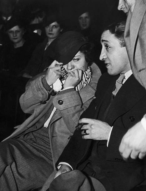 Brothel madam Polly Adler hides from the cameras at her trial in New York City 14th March 1935. She later wrote a best-selling autobiography