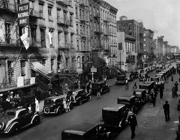 Cars line the curbs of Saint Mark's Place on New York on a Sunday. 1938.