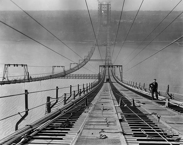 Full-length image of a worker pausing near the top of the George Washington Bridge during its construction New York City circa 1930.