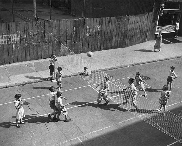 Group of children play volleyball on their makeshift court on Thompson Street in the SoHo neighborhood of New York City.