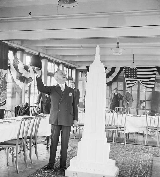 New York NY- Al Smith New York's most popular citizen doffing his famous derby off to a replica of the Empire State Building at the dedication