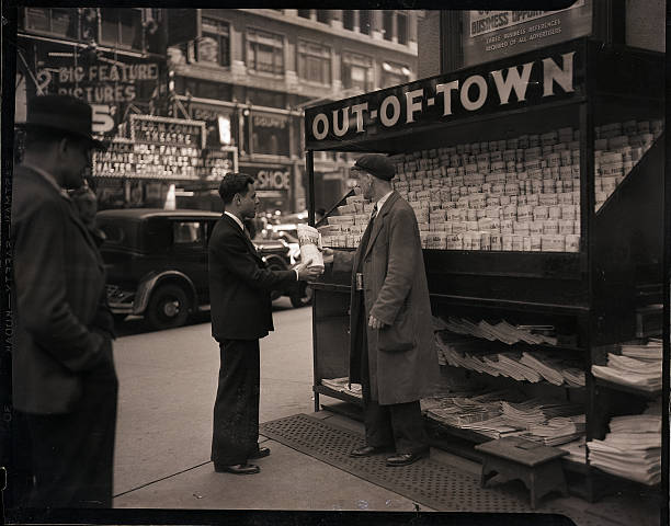 New York NY- Photo shows the out-of-town newspaper stand in Times Square probably the most famous newsstand in the city. Transients tourists