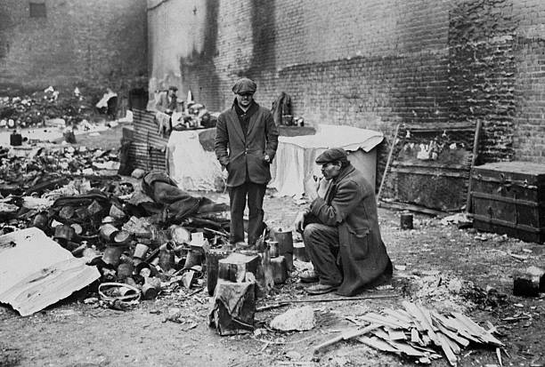 Squatters in a 'Shanty Town' on 38th St. And Tenth Ave. staying around fire to keep themselves warm.