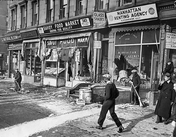 Stores on the corner of Lenox Avenue between 129th and 130th Sts. After a night of rioting in Harlem.