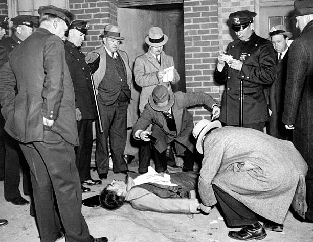 The body of Tommy Protheroe lies outside his apartment house in Sunnyside Queens where he and his female companion Elizabeth Connors were shot by