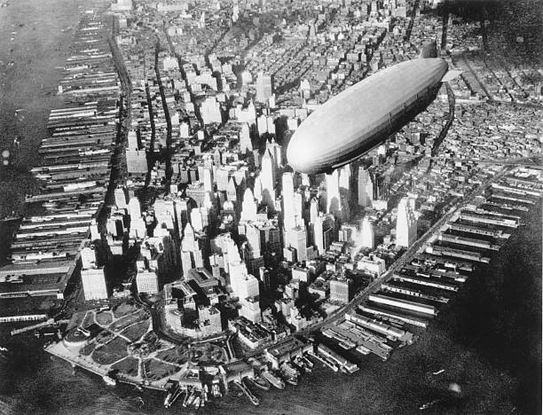 View of the USS Akron a US Navy airship meant to be the first flying aircraft carrier flying over New York City early 1930s.