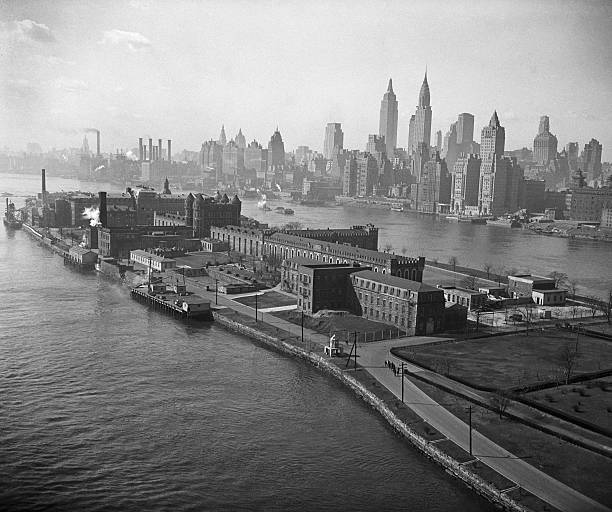 Welfare Island NY- View of prison buildings on Welfare Island in New York City. Manhattan is visible in background.