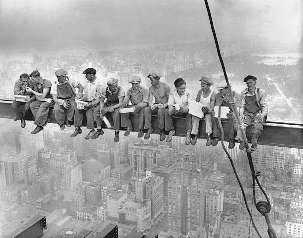 While New York's thousands rush to crowded restaurants and congested lunch counters for their noon day lunch these intrepid steel workers atop the
