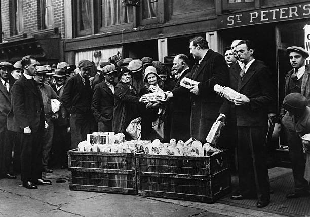 William I. Sirovich and Heywood Brown shown above with the Reverend Raymond Norman are dealing out bread and coffee to hungry and jobless at St.