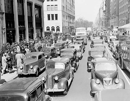 1930s PEDESTRIAN CROWDS AND TRAFFIC ON 5th AVENUE NYC CARS TAXIS BUSES STREET CONGESTION AT 67TH STREET
