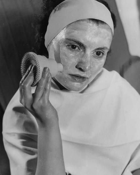 An unidentified woman demonstrates of new beauty aid New York New York 1920s or 1930s.
