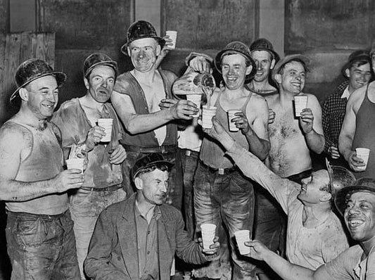 Construction workers celebrate the holing through of the last connecting link for the Sixth Avenue Subway between Eighth and 53rd Streets.