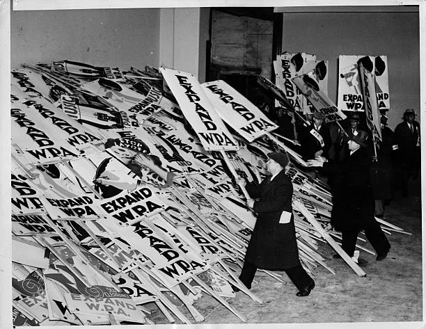 Crowd protests the curtailment of the WPA and piles picket signs outside Madison Square Garden.