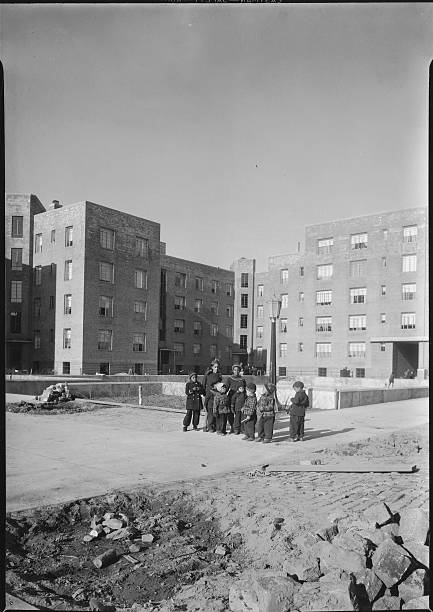 Group of children stand in the grounds of the River Houses a federally-funded housing project built by the Public Works Administration.
