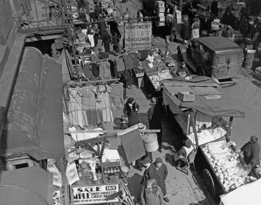 High angle view of a pushcart market along a sidewalk on the Lower East Side of Manhattan in New York City New York circa 1935. Above the stalls