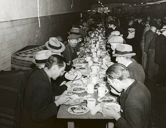 Homeless men are at the Bowery Mission eating their Thanksgiving Day Dinner.