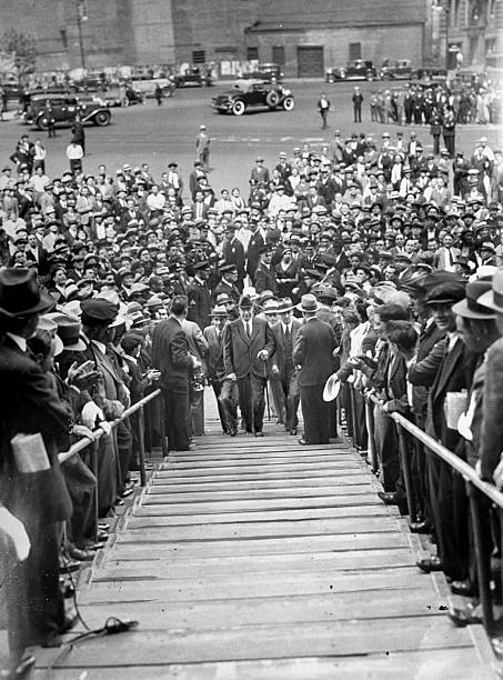 Judge Samuel Seabury and his aides surrounded by applauding crowds outside the Federal Court Building in Manhattan where he currently is involved in