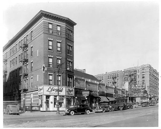 Lloyd's restaurant and other store fronts and buildings in New York City circa 1930.