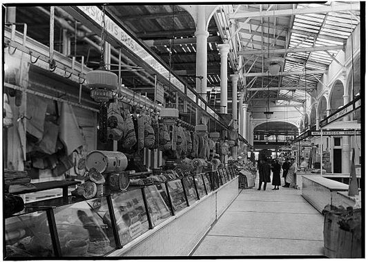 Located at Washington and Fulton Streets NYC. View of meat stalls with shoppers.