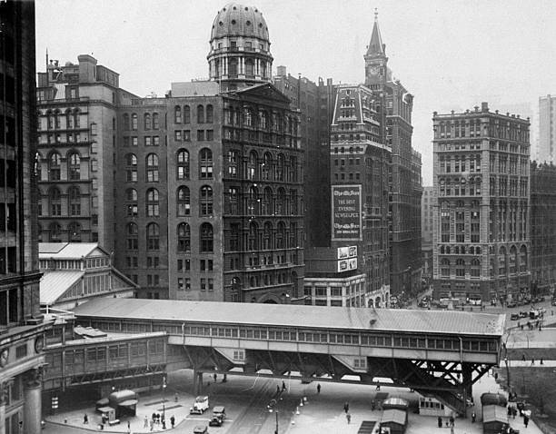Manhattan passenger terminal of Brooklyn Bridge which crosses Park Row before it was removed to improve appearance of City Hall Park. At left center