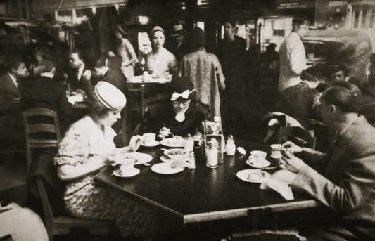 Office workers lunching in a restaurant New York USA early 1930s. The reflection of car can be seen in the window.
