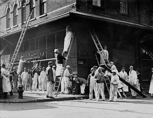 Painters working on buildings in Washington Market as part of President Roosevelt's Federal Relief Work program aimed at putting four million people
