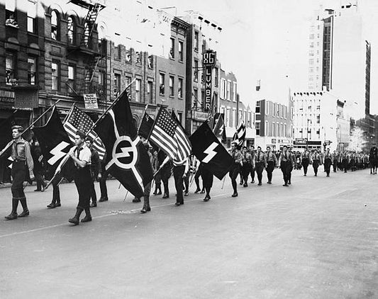 Parade of the German American Bund through New York with the Stars and Stripes flag being carried alongside the Nazi banner.