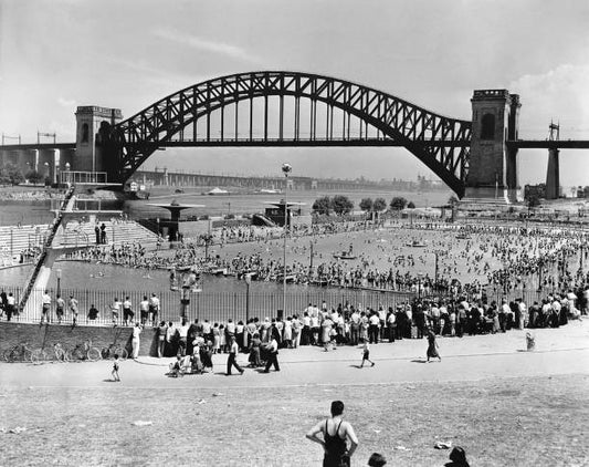 Photo taken in July 1936 shows the Hell Gate Bridge in the background and hundreds of holidaymakers came to refresh themselves in the vast basin of