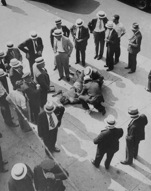 Police investigators examine the body of Murray Marks.