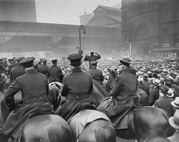 Police on horseback quell a communist demonstration held outside City Hall.