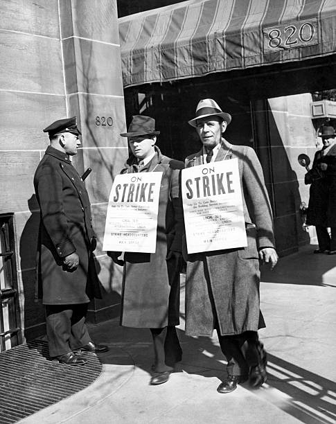 Service Employees International Union members picket in front of Governor Lehman's residence on Park Ave New York New York circa 1938 .