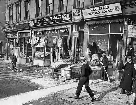 Stores on the corner of Lenox Avenue between 129th and 130th Sts. After a night of rioting in Harlem.
