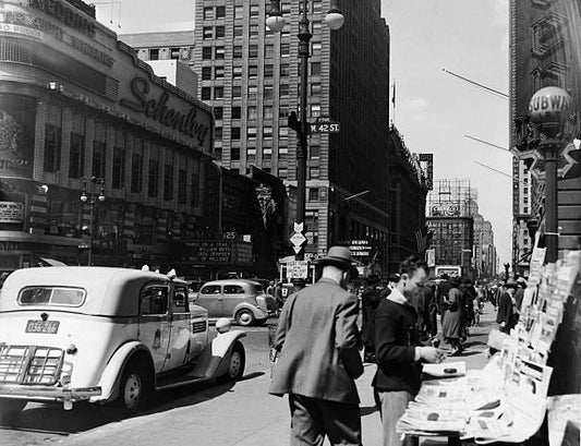 Street scene in Times Square with street vendors and traffic on 42nd Street New York City circa 1936.