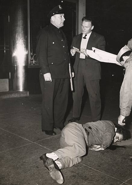 The fiesta at Little Italy turns tragic as a dead body lies on the sidewalk of Mulberry Street. A uniformed police officer and perhaps a reporter