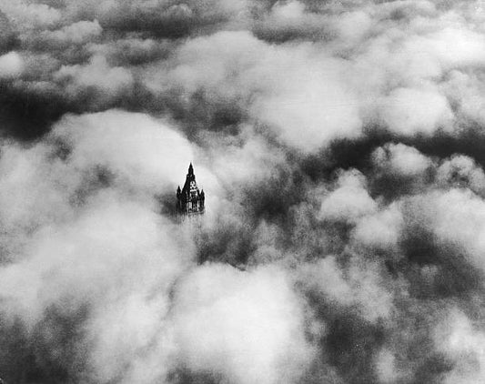 The top of the Woolworth Building in New York above the clouds. It was designed by Cass Gilbert and was the second tallest building in the world at