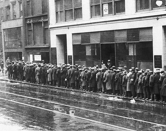 Unemployed men wait in long lines for bread and handouts during the Great Depression.