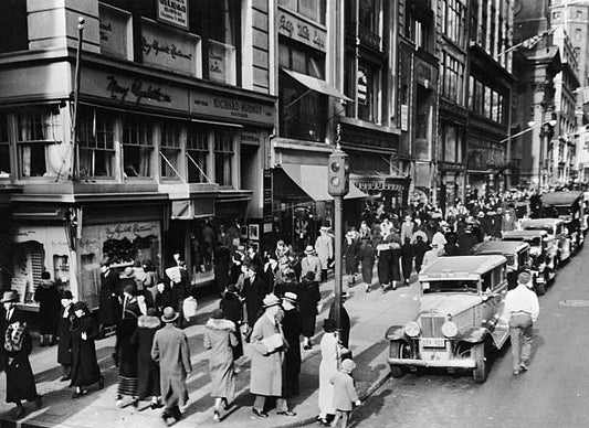 View of a crowded Manhattan sidewalk New York New York circa 1930.