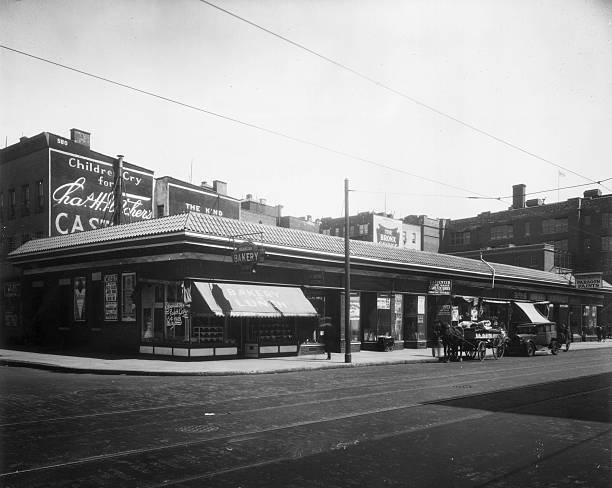View of a retail block which is located between 641-59 East 180th Street Bronx New York City. A bakery a lumber and heating supply store a shoe