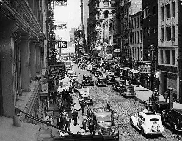 View of pedestrian and vehicle traffic along Fulton Street at the intersection of Dutch Street near the BMT and 8th Avenue subway stattion New