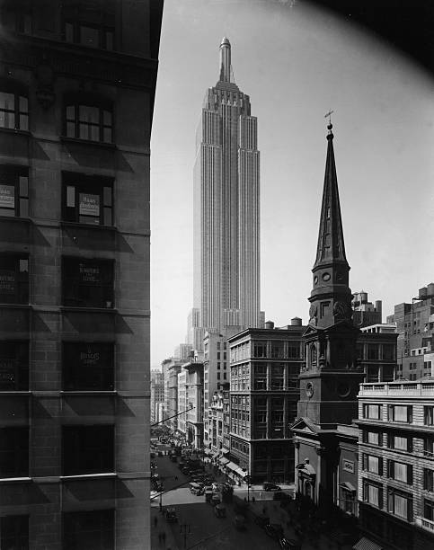 View of the Empire State Building seen from Fifth Avenue and 39th Street Manhattan New York City circa 1935.