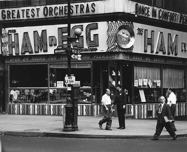 View of the corner of Broadway and 51st Street and the Ham n Egg diner New York New York 1930s or 1940s.