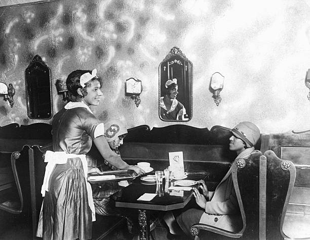 Waitress serves customers lunch in a restaurant in Harlem.