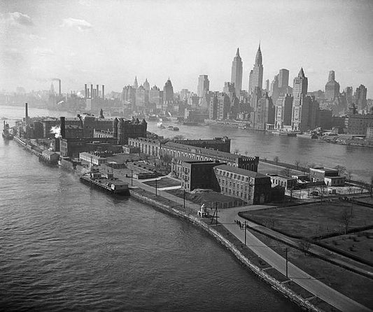 Welfare Island NY- View of prison buildings on Welfare Island in New York City. Manhattan is visible in background.