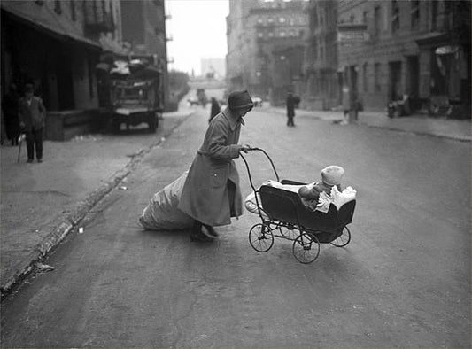 Woman with a baby in a pram in New York City circa 1930.