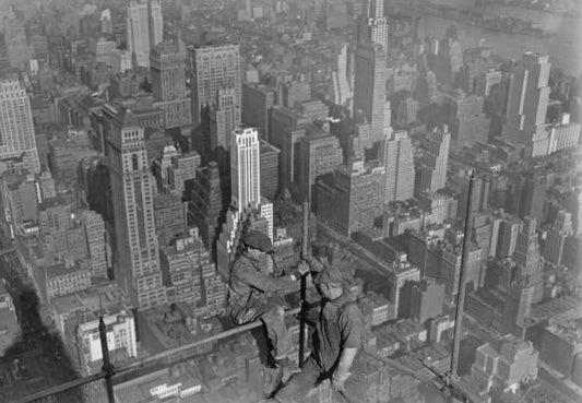 Workers in conversation atop the scaffolding of the 102-storey Empire State Building in the borough of Manhattan in New York City New York circa