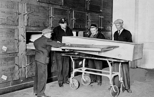 Workers look at repository in basement of mortuary at Bellevue Hospital where unclaimed bodies remain for thirty days. After that time they are