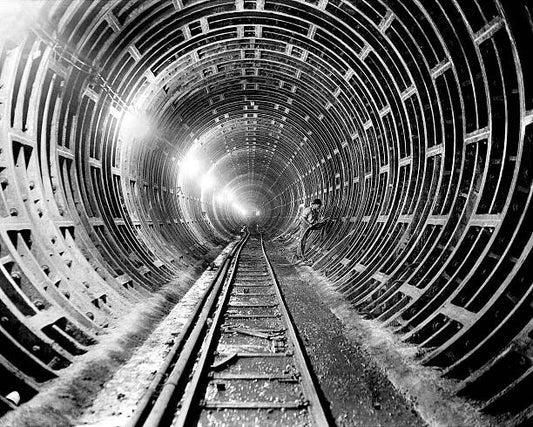 Workman caulks joints with lead to make them waterproof during the construction of the 6th Avenue subway tunnel.