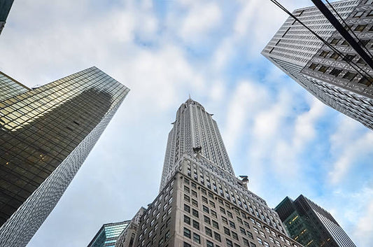 Chrysler building surrounded by other skyscrapers as seen from directly below